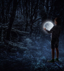 Little boy holding moon at night. Mixed media