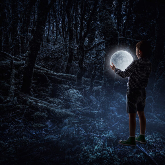 Little boy holding moon at night. Mixed media